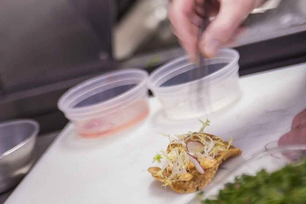 A chef meticulously prepares food on a cutting board, highlighting the art of cooking in a professional kitchen - Chef Aspen