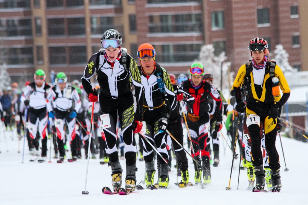 Competitors on skis racing down the slopes at the World Cup Skiing event in Aspen, highlighting their athleticism.