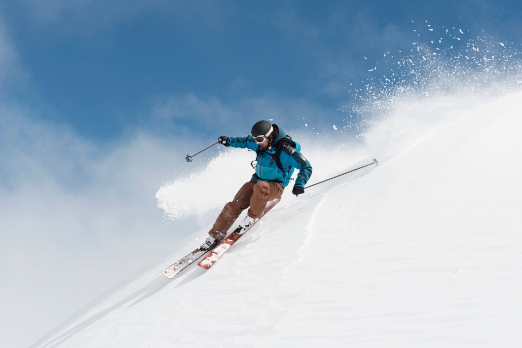 A skier navigates a steep, snow-covered slope at the World Cup Skiing in Aspen, emphasizing the challenging conditions.