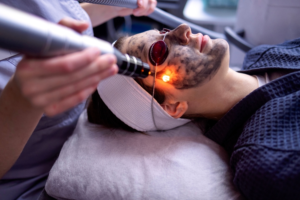 A woman receiving a facial laser treatment at Neuro Spa, the best spa in Aspen, focused on skin rejuvenation.