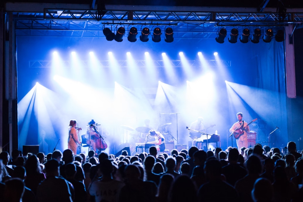 A live band captivates the audience on stage at the X Games Concerts, featuring diverse music genres in a vibrant atmosphere.