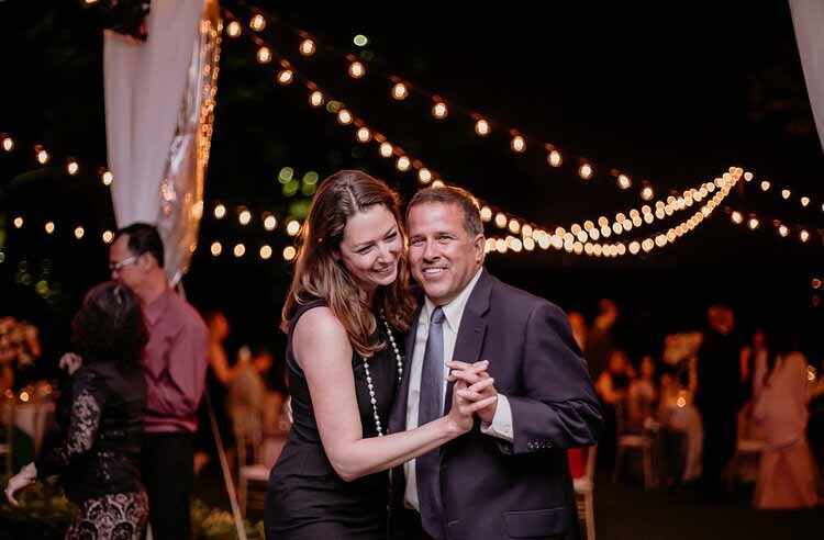 A joyful wedding celebration featuring individuals dancing at Aspen Luxury Concierge.