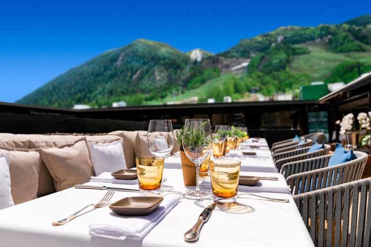 Betula Aspen restaurant featuring breathtaking mountain views, surrounded by the beauty of the mountainside landscape.