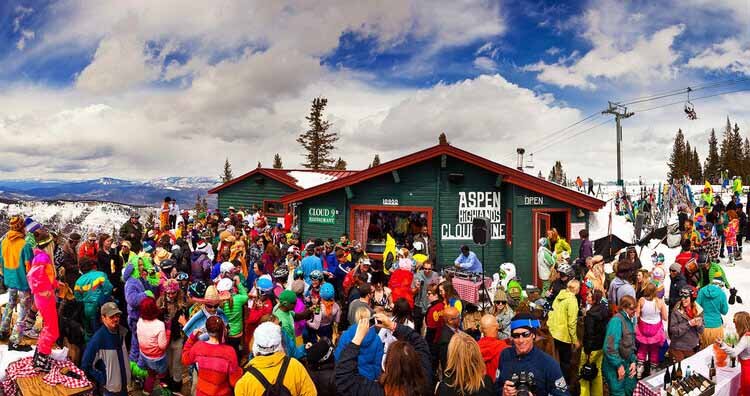 A lively crowd gathers at Aspen Cloud 9 ski resort, enjoying the winter atmosphere and scenic mountain views.