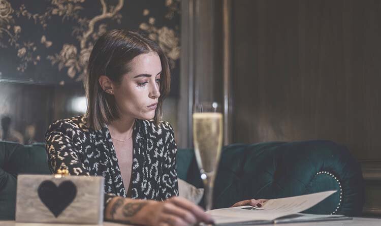 A woman ordering at a restaurant in Aspen, enjoying warm and inviting setting.