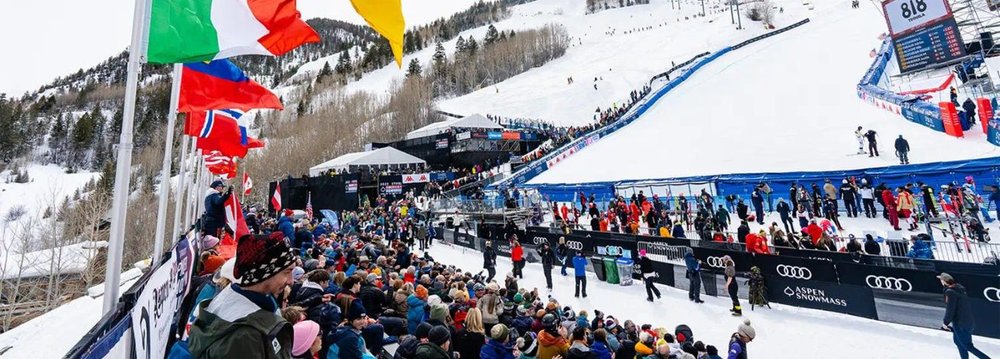 A crowd gathers to watch an exciting ski race at the World Cup Skiing Aspen event.