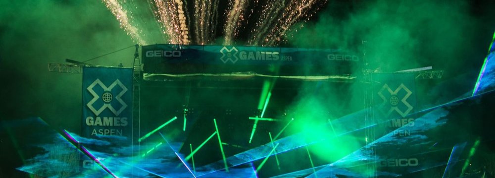 Lively lights and fire works up the sky at a concert, adding excitement to the X Games Concerts experience for attendees.