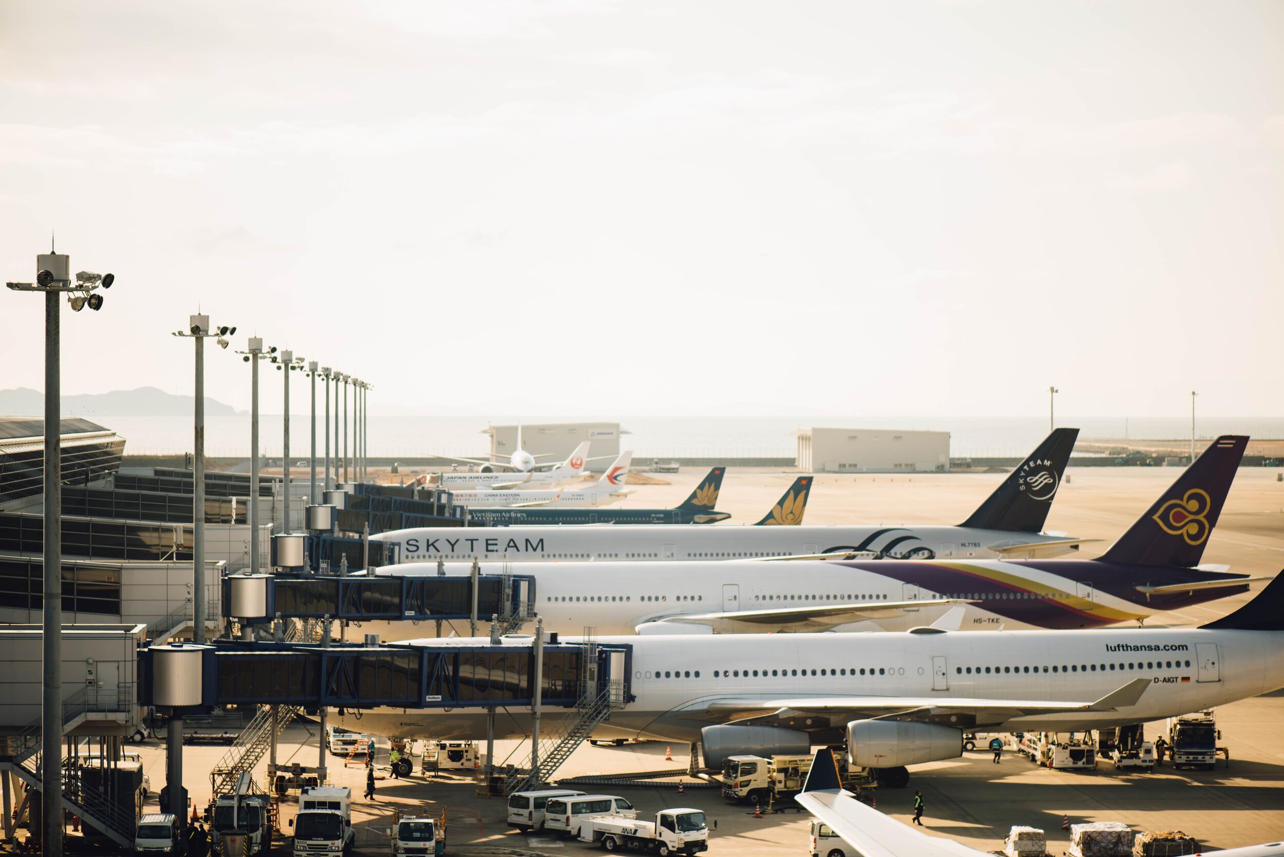 A row of high class airplane parked at an airport, showcasing the elegance of Aspen luxury travel.