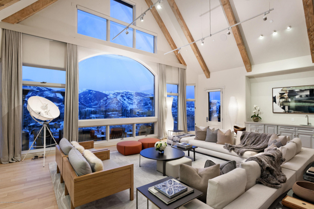 A cozy living room featuring large windows that showcase stunning mountain views.