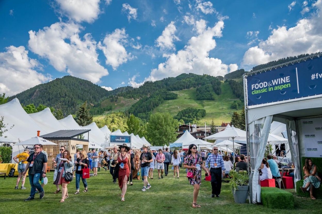 Wagner Park with lots of people highlights a vibrant food and wine festival events in aspen in summer