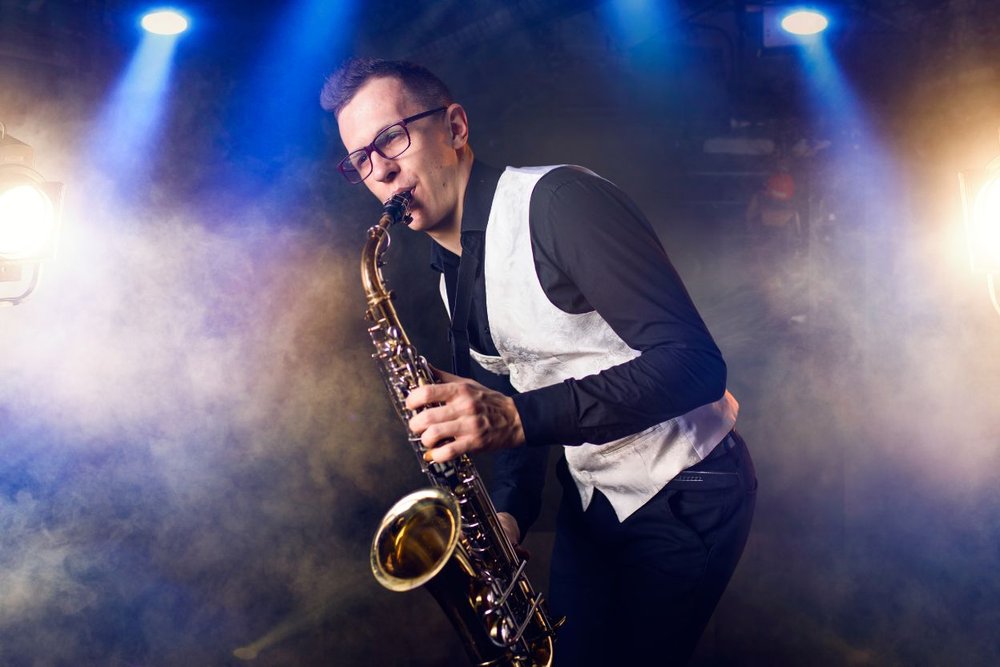 The musician is playing saxophone during the aspen music festival