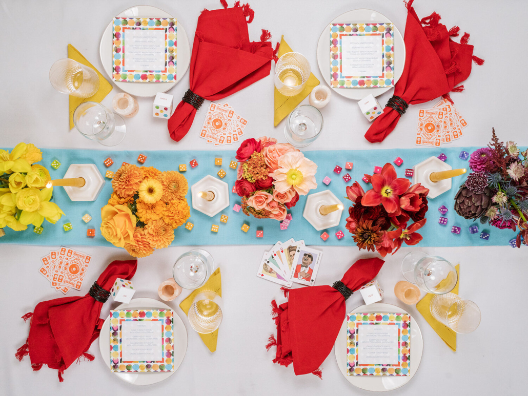 A colorful dining arrangement showcasing red napkins and stylish place settings, ideal for special occasions.