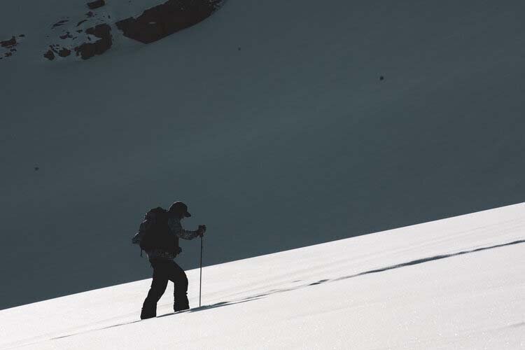 A person skillfully navigates snowy terrain on skis, embodying the essence of winter recreation.