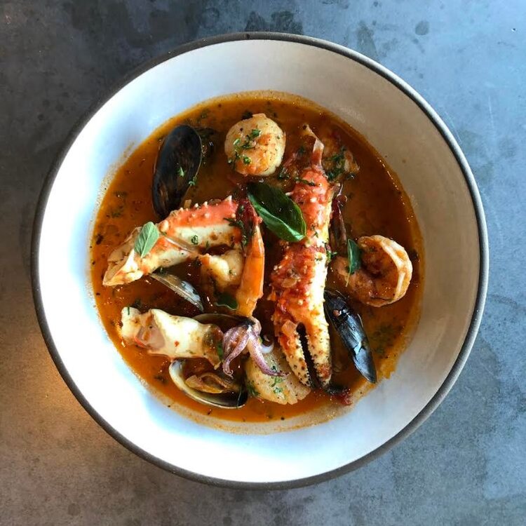 A delicious bowl of seafood soup  showcasing a delightful culinary presentation is one of the latest in Aspen eats