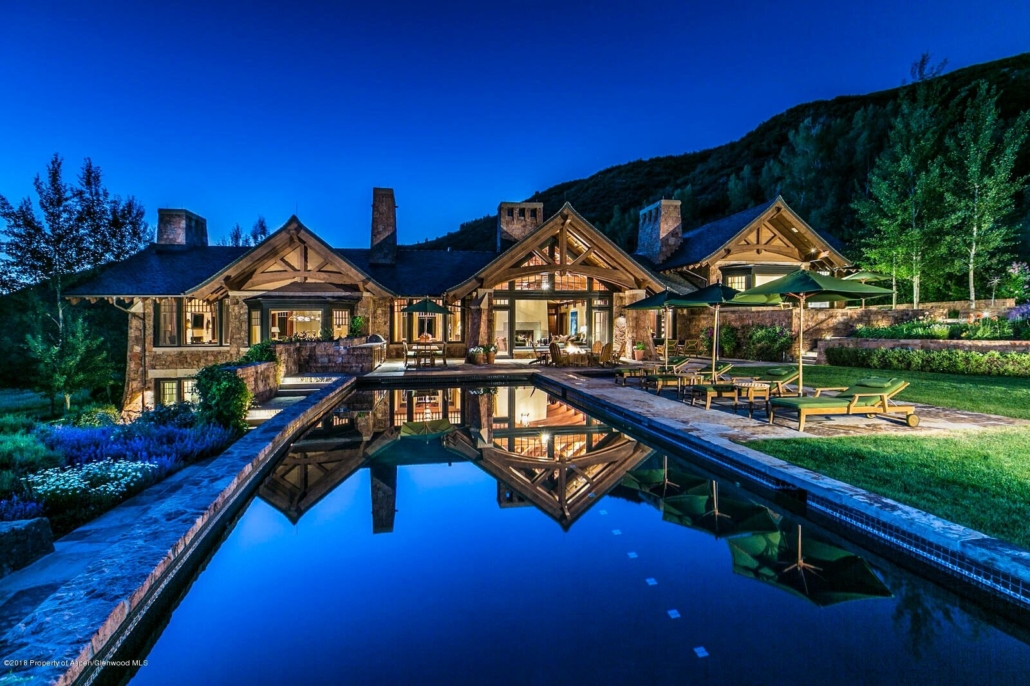 A spacious home featuring a pool, surrounded by stunning mountain views in a serene setting.