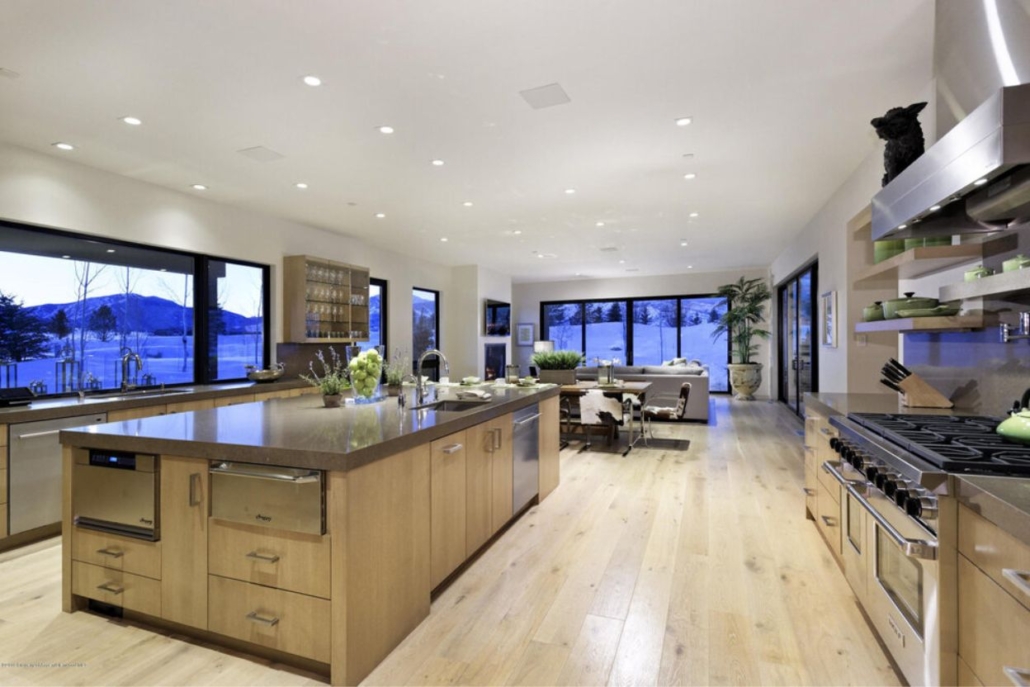 A spacious kitchen featuring a large space and elegant wooden floors, the best option for selecting the ideal luxury rental in Aspen.