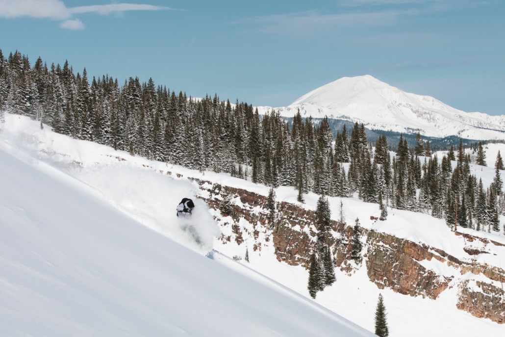 A professional skier is descending a mountain in Aspen