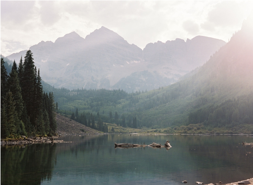 A serene lake nestled among majestic mountains and lush trees, reflecting the beauty of nature.