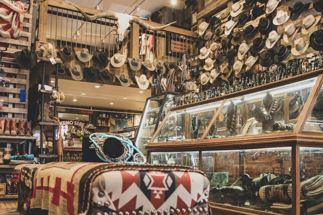 A vibrant store filled with a variety of hats and unique items for sale, showcasing local craftsmanship.