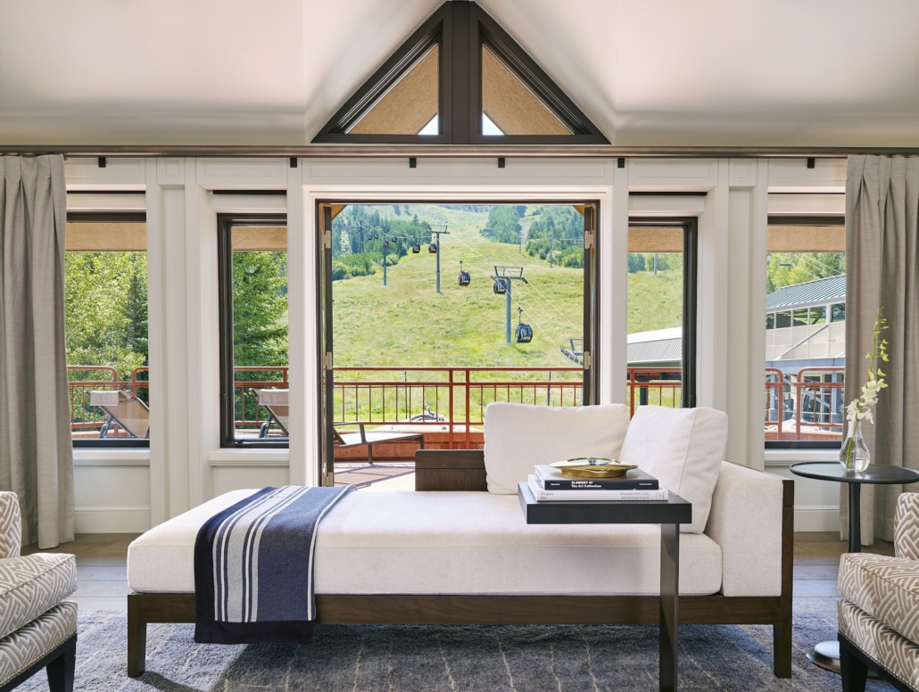 Cozy bedroom with expansive windows offering a breathtaking view of the surrounding mountains offered by The Little Nell with Reservations Policy Aspen 2020