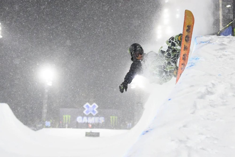 The athlete invited to the x games in aspen is performing in his snowboard exhibition