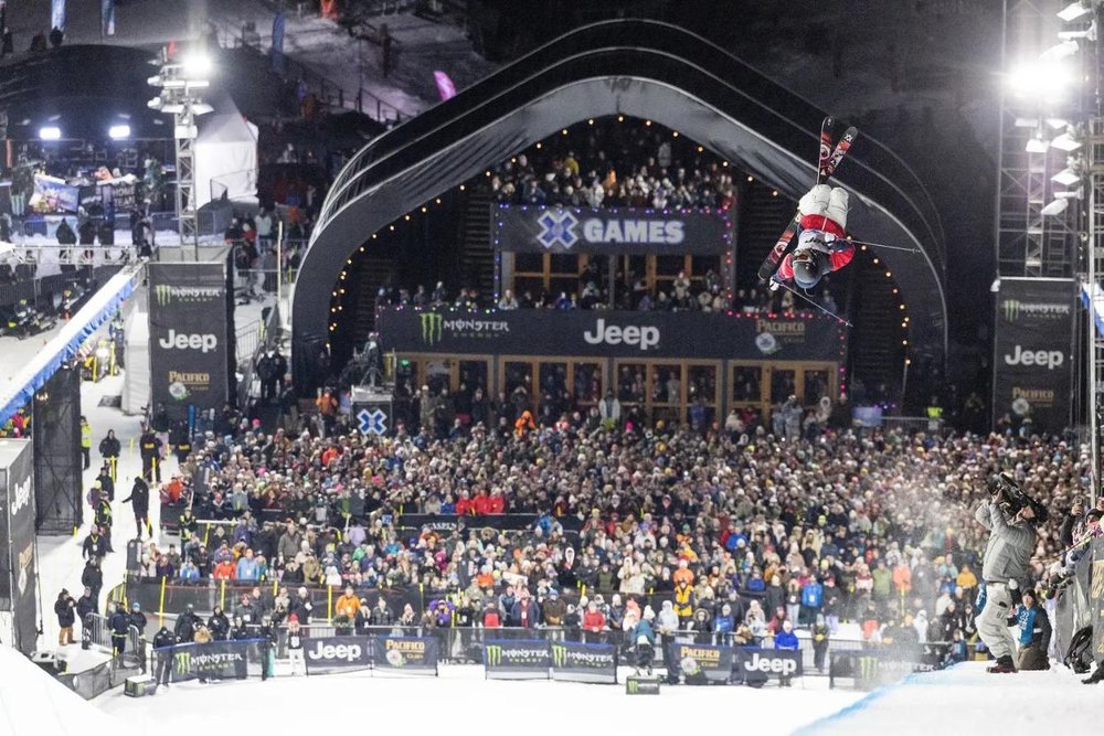 The professional skier is performing in the middle of the X Games concert in Aspen