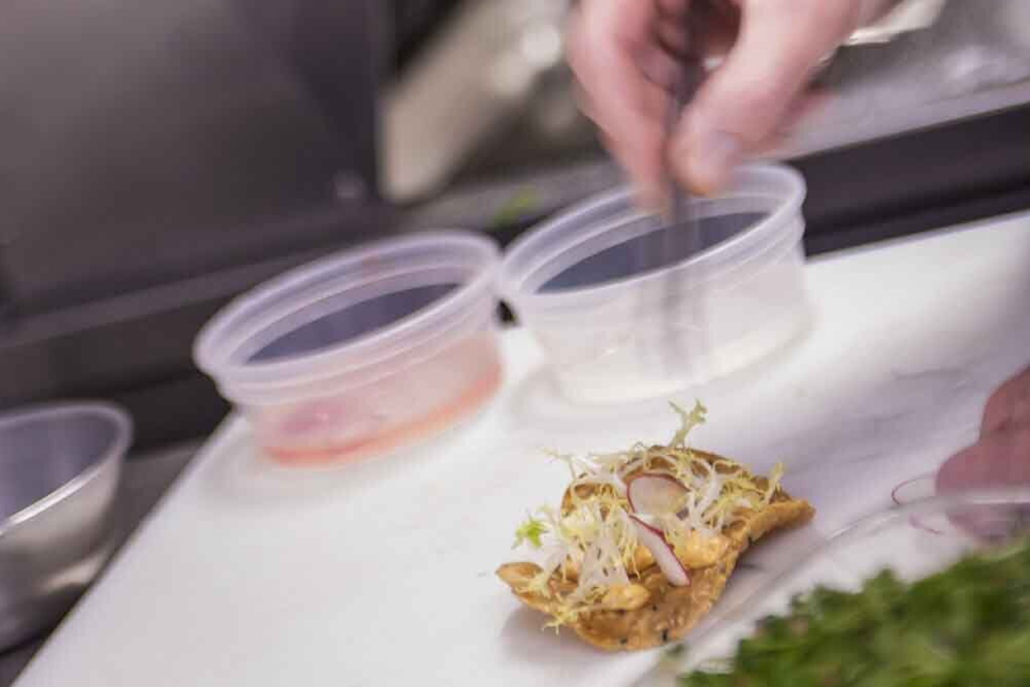 A chef meticulously prepares food on a cutting board, highlighting the art of cooking in a professional kitchen - Chef Aspen