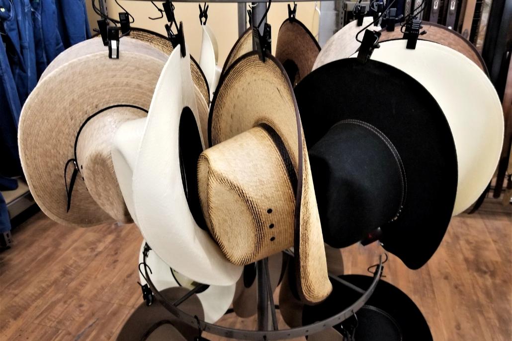 A collection of stylish hats arranged in a store display at Aspen Hats, known as the best hat store.