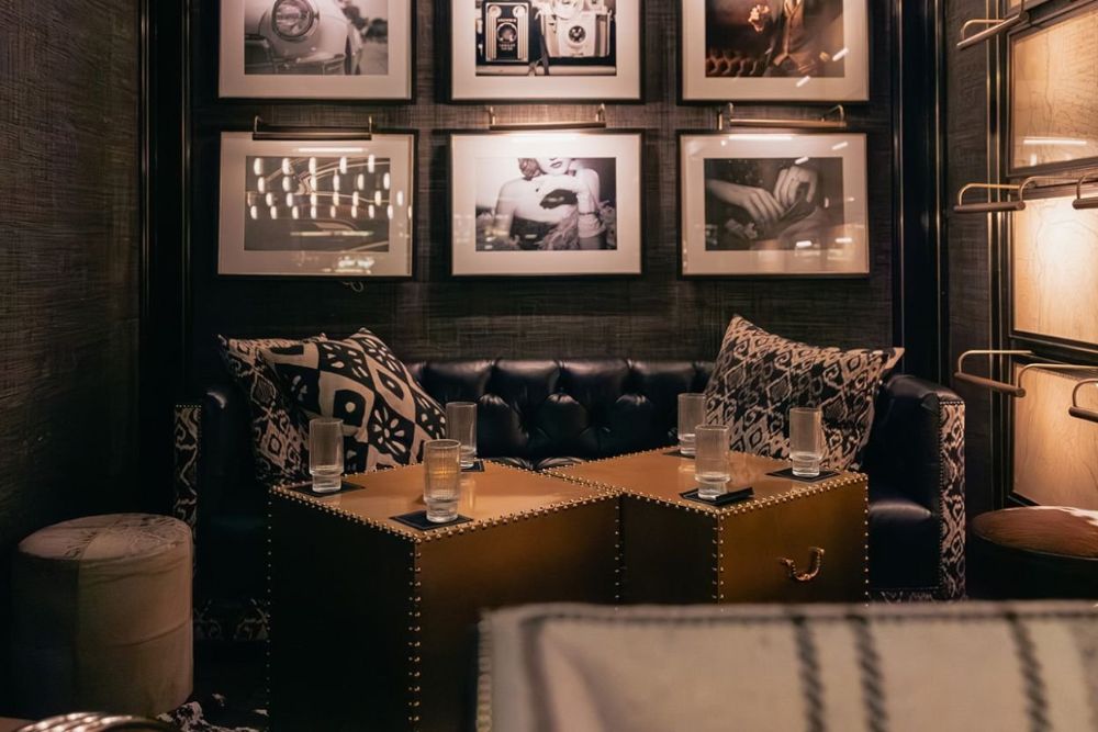 A cozy room featuring a couch and framed pictures adorning the walls, creating a warm atmosphere.