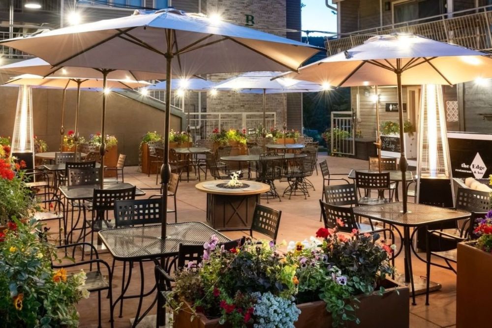 Nighttime view of an outdoor restaurant, creating a cozy atmosphere.