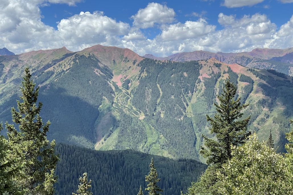 Scenic view of mountains from the summit of Aspen Mountain, showcasing the beauty of Aspen Trails hike.