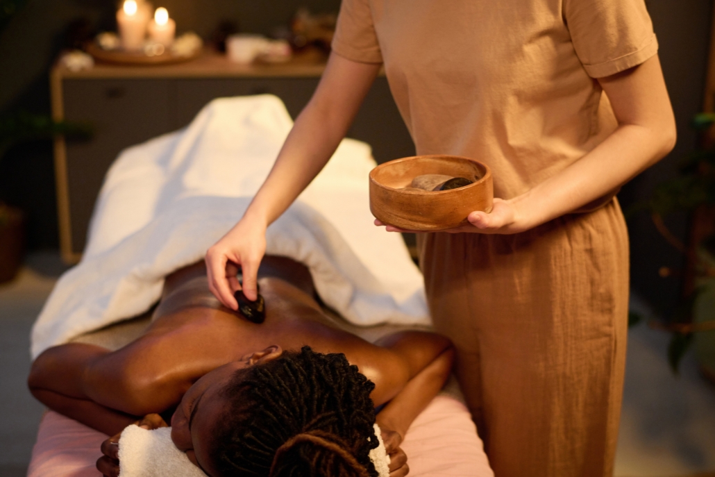 A woman receiving a relaxing massage in a luxury spa in Aspen during September, surrounded by serene decor.