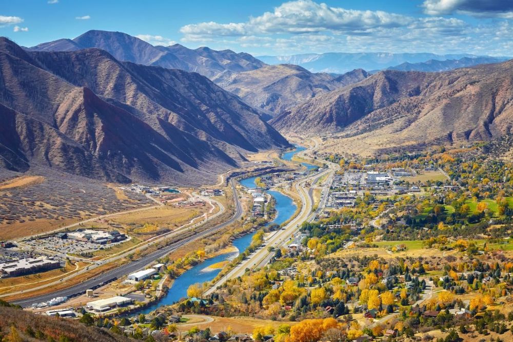 View of the Glenwood springs with beautiful framed by mountains and a river, showcasing its natural surroundings.