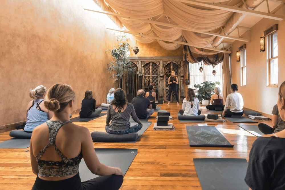 ALC guests are practicing yoga Aspen at a luxurious location with relaxing atmosphere.