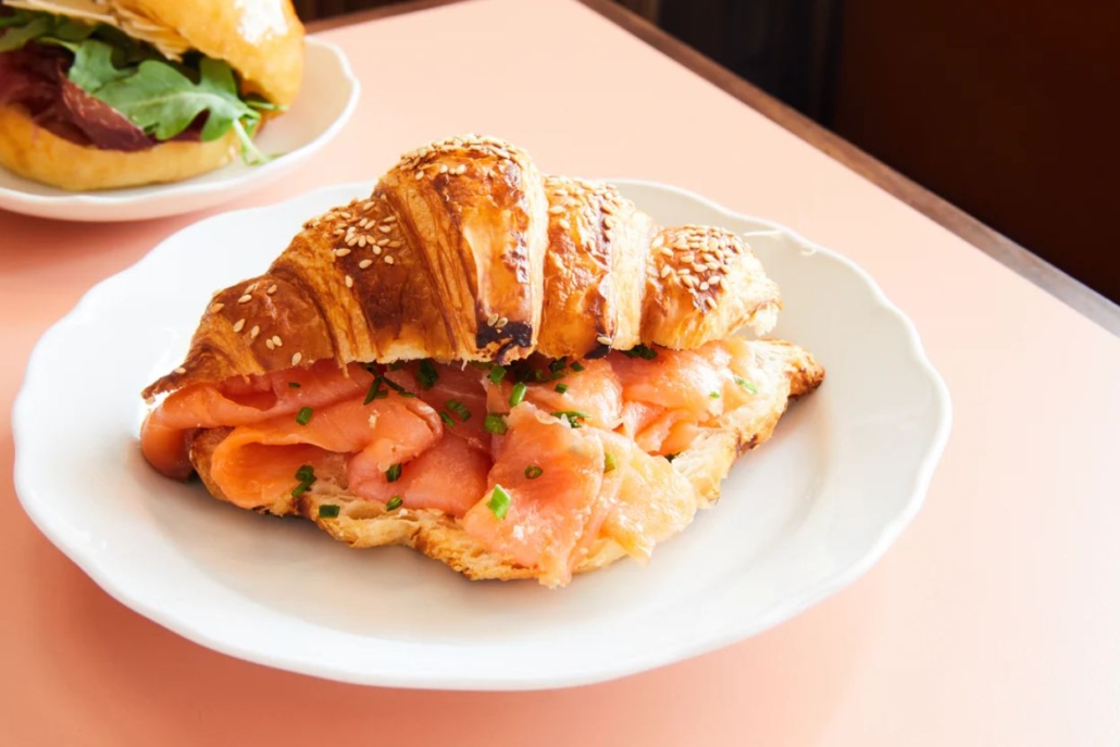 A delicious croissant with salmon, served by Sant Ambroeus Coffee Bar.