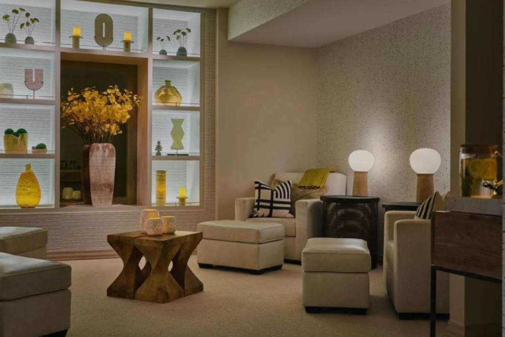 A cozy spa lobby featuring a large a comfortable couch, and relaxing atmosphere with aesthetic interior design.