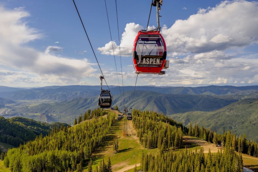 A scenic gondola ride on the Silver Queen Gondola, surrounded by lush trees and majestic mountains.