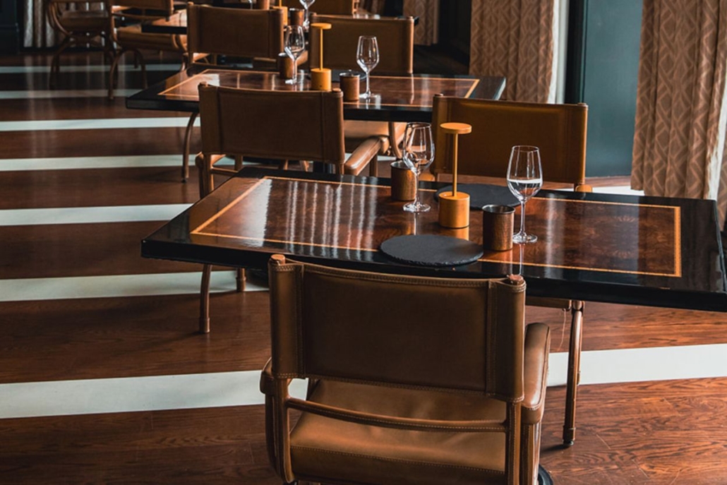 Cozy restaurant in Aspen with wooden tables and chairs, perfect for dining in December's winter charm.