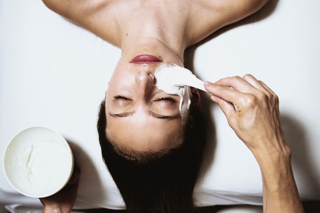 A woman enjoys a rejuvenating facial treatment at Aspen Spa, surrounded by a serene and relaxing atmosphere.