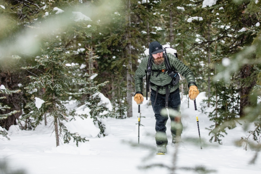 A skier navigates a snow-covered trail, showcasing the beauty of Aspen's winter hiking opportunities in December.