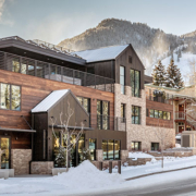 Aspen Street Lodge with a stunning mountain view and snow-covered ground, showcasing a picturesque winter landscape.