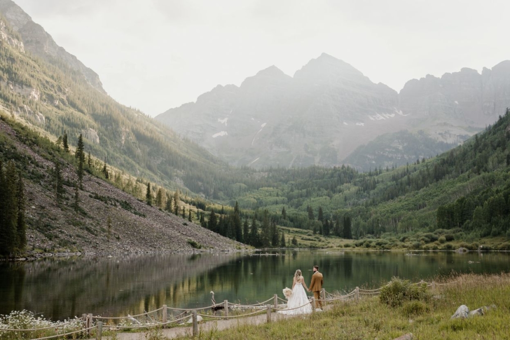 A picturesque scene of Crater Lake, featuring a couple's elopement, beautifully photographed by a Colorado wedding expert.