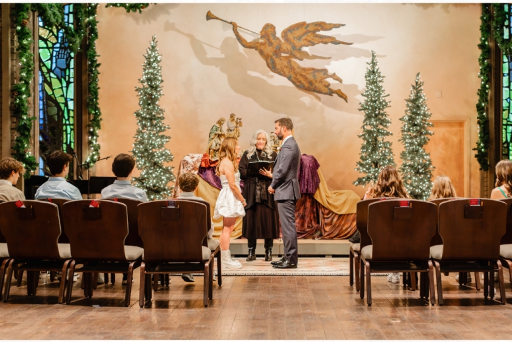 A charming wedding ceremony in Aspen Chapel, highlighted by an angel statue, symbolizing love and protection.