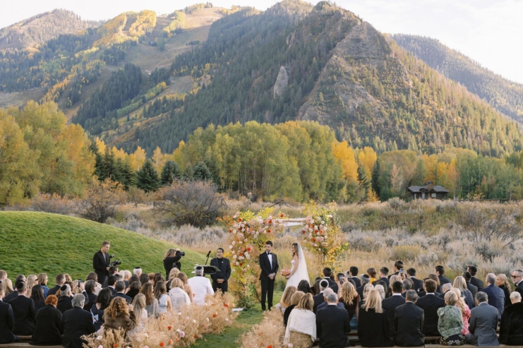 A picturesque wedding ceremony set against the stunning backdrop of the Aspen Mountains at Aspen Meadows Resort.
