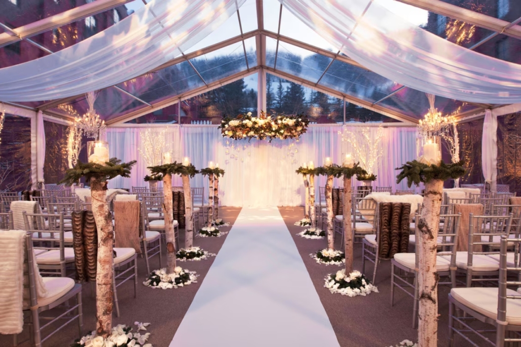 A beautifully arranged wedding ceremony inside a tent at The St. Regis Aspen Resort, showcasing elegance and romance.