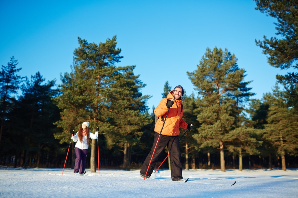 A couple enjoys cross-country skiing in the snowy terrain of Aspen, Colorado, showcasing a winter scene in December.