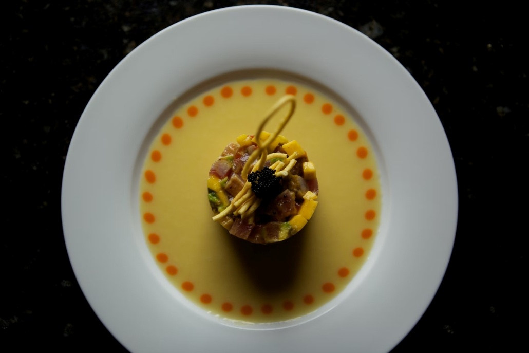 A white plate featuring delicious dish, cook by Parc Aspen in December.