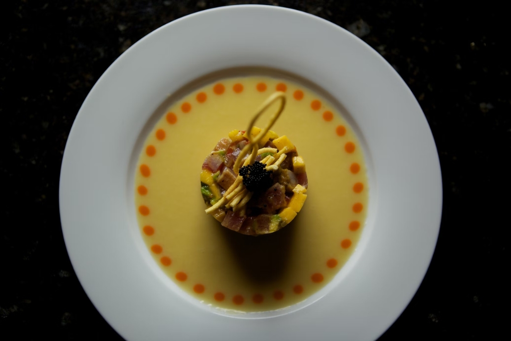 A white plate featuring delicious dish, cook by Parc Aspen in December.