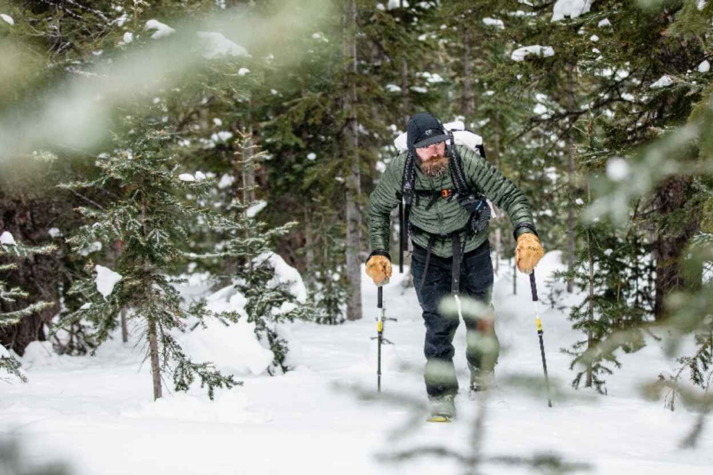 A skier navigates a snow-covered trail, showcasing the beauty of Aspen's winter hiking opportunities in December.