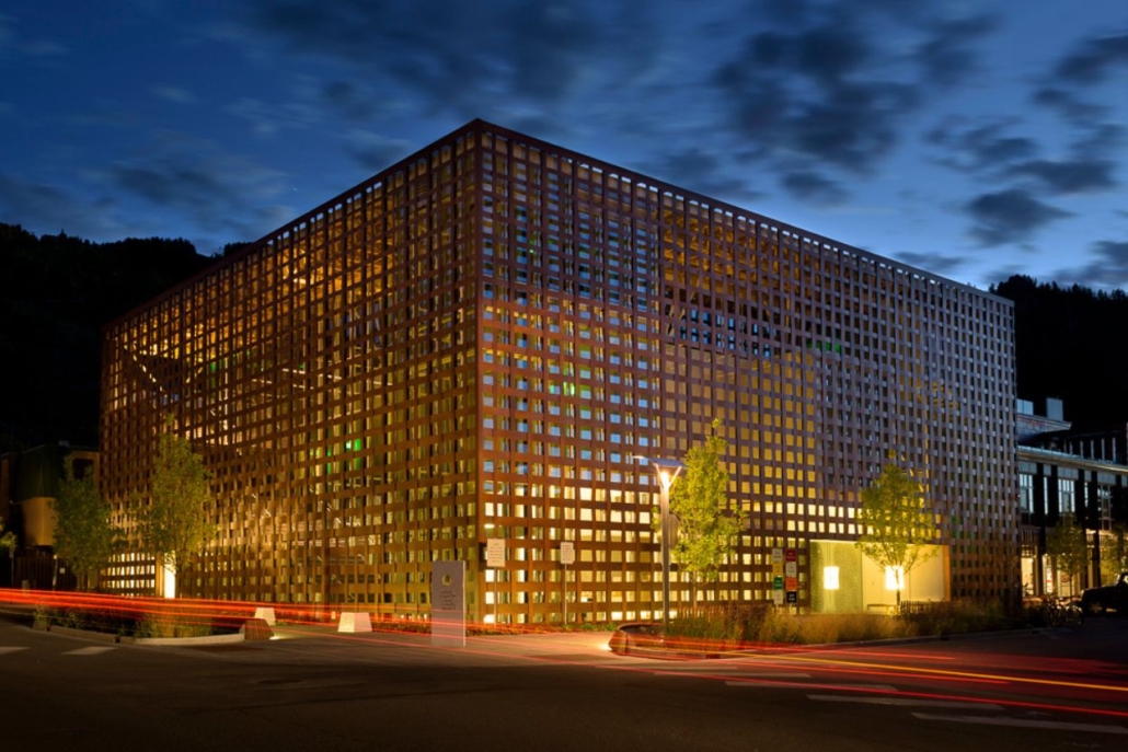 A large wooden structure on the side of the road, featuring the Aspen Art Museum's modern architectural design.